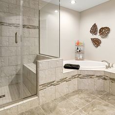 a bathroom with a walk in shower next to a bath tub