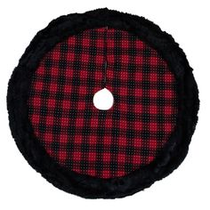 a red and black plaid pattern on the side of a round object with a hole in it