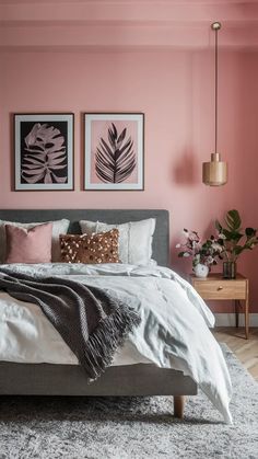 a bedroom with pink walls and grey bedding