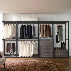 an open closet with clothes hanging on shelves