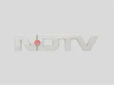 the logo for nttv is shown on a gray background with white letters and a red dot