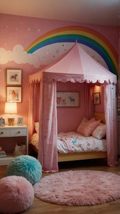 a child's bedroom decorated in pink and white with a rainbow theme on the wall