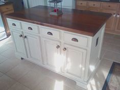 a large kitchen island with two doors and drawers