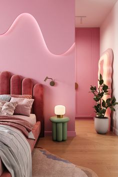 a bedroom with pink walls and wooden flooring in the room is furnished with an upholstered bed