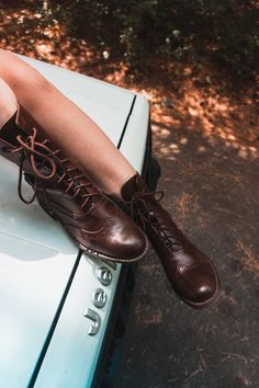 One of our bestsellers, our Brown Victorian Lace Up Ankle Boots are handcrafted down to the sole using the goodyear welt construction method. Special attention and care is taken when making the classic, but forever modern, brogue design. The lace up feature allows you to wear them a variety of ways! HIGHLY recommended to order 1/2 small than your normal shoe size. (Trust us on this, please) Free exchanges - you send us your boots and we'll send you the size you need no charge Can be resoled at a Womens Brown Lace Up Boots, Victorian Ankle Boots, Lace Up Brown Boots, Vintage Oiled Leather Ankle Boots, Vintage Oiled Leather Moto Boots For Fall, Vintage Oiled Leather Moto Boots, Vintage Oiled Leather Moto Boots With Leather Footbed, Vintage Lace-up Ankle Boots With Leather Lining, Vintage Brown Leather Moto Boots With Round Toe