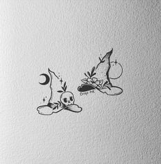 an ink drawing of two witches on a white paper with the words, witch and skull