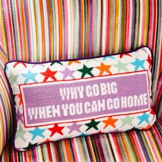 a colorful striped chair with a pillow that says, why do you care when you can't make it?