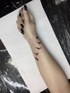 a woman's arm with birds on it