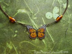 a necklace with a butterfly on it