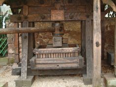 an old wooden bench sitting under a roof