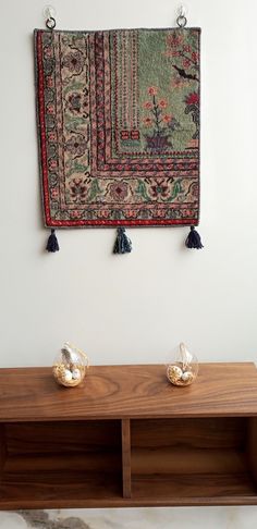 a wooden shelf with two pairs of shoes sitting on top of it next to a rug