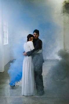 A different style for your wedding photos is to add in smoke bombs!   This was shot at a warehouse in Perth, Australia for a unique, modern with a twist wedding. Bride wears a two piece wedding outfit and groom in a velvet jacket. Posing by cuddling each other.  Wedding Trends  #WeddingTrends #WeddingPhotography #WeddingPhoto Two Piece Wedding Outfit, Warehouse Wedding, Wedding Photo Ideas, Perth Australia, Velvet Jacket, Bride Wear