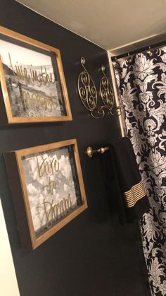 the bathroom is decorated in black and white with gold accents on the shower curtain rod