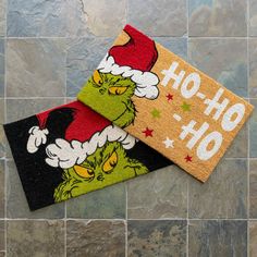 two doormats with the grinch on them sitting on top of a tile floor