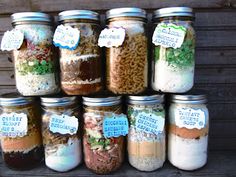 there are many jars with different types of food in them and labels on the lids