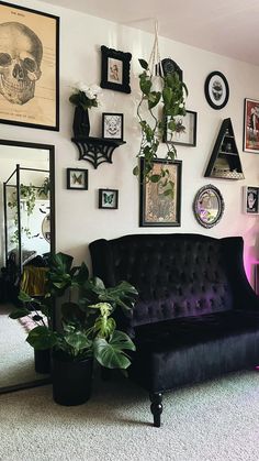 a living room filled with furniture and pictures on the wall