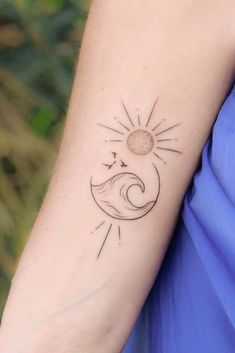 a woman with a sun and moon tattoo on her arm