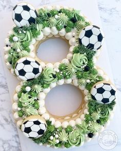 a cake decorated with soccer balls on top of a white countertop next to an instagram post