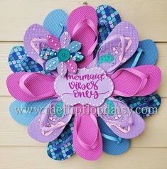 a pink and blue flip flop wreath on a wall