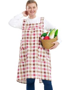 a woman in an apron holding a basket full of fresh fruits and veggies