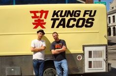 two men standing in front of a truck with the words king fu tacos written on it