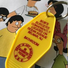 a yellow keychain with an ad for bob's burgers on it