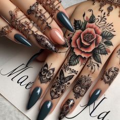 a woman's hands with tattoos and manies on them