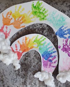 two paper plates with handprints on them sitting on a granite surface next to each other