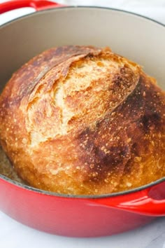 a loaf of bread in a red pot