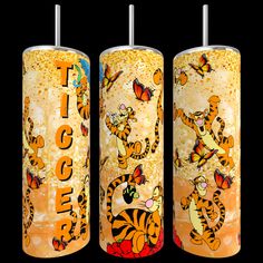 three orange and yellow tumbles with tiger images on them, one has a butterfly