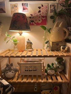 a shelf with some stuffed animals on it and a lamp in the corner next to it