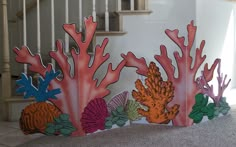 an image of corals and seaweed on the ground in front of a stair case