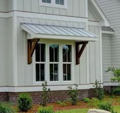 a white house with an awning over the front door