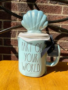 a coffee mug with the words part of your world on it sitting on a table