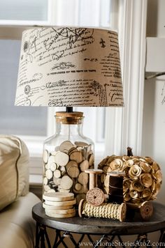 a lamp that is sitting on top of a table next to a vase with coins in it