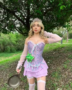 a woman in a purple corset is posing for the camera