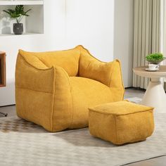 a yellow chair and ottoman in a room