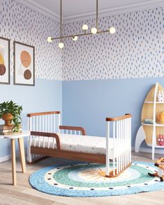 a child's bedroom with blue walls and white furniture