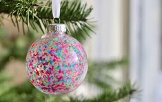 an ornament hanging from a christmas tree with sprinkles on it