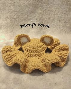 there is a crocheted teddy bear with ears on it's head and the words berry's home written in black