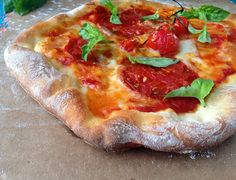 a pizza sitting on top of a wooden cutting board