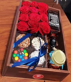 a wooden box filled with candy and roses