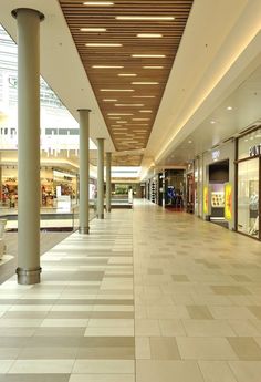 an empty shopping mall with several stores in the background