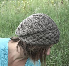 a woman wearing a knitted hat in the grass