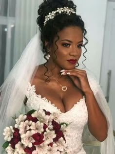 a woman in a wedding dress holding a bouquet and looking at the camera with her hand on her chin