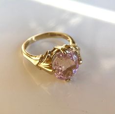 14k gold ring with stunning kunzite center! The oval pink kunzite is 3.65 CT's and is approximately 12x9 mm. Large fan shaped prongs give this ring an elegant look and extra security for the gemstone. The ring weights 3.0 dwts And is a size 7 Pink Gold Wedding Ring, Gemstone Gold Ring, Oval Diamond Cut Amethyst Ring, Oval Amethyst Ring With Diamond Cut, Formal Oval Kunzite Rings, Pink Kunzite Wedding Rings, Pink 14k Gold Amethyst Ring, Pink Oval Amethyst Ring For Weddings, Wedding Pink Kunzite Rings