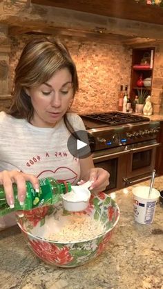 a woman pouring something into a bowl on top of a counter