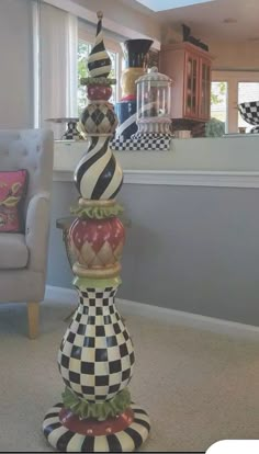 a tall glass vase sitting in the middle of a living room