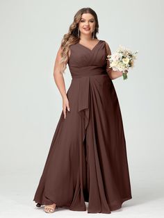 a woman in a long brown bridesmaid dress holding a bouquet and posing for the camera