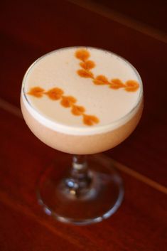 a drink sitting on top of a wooden table